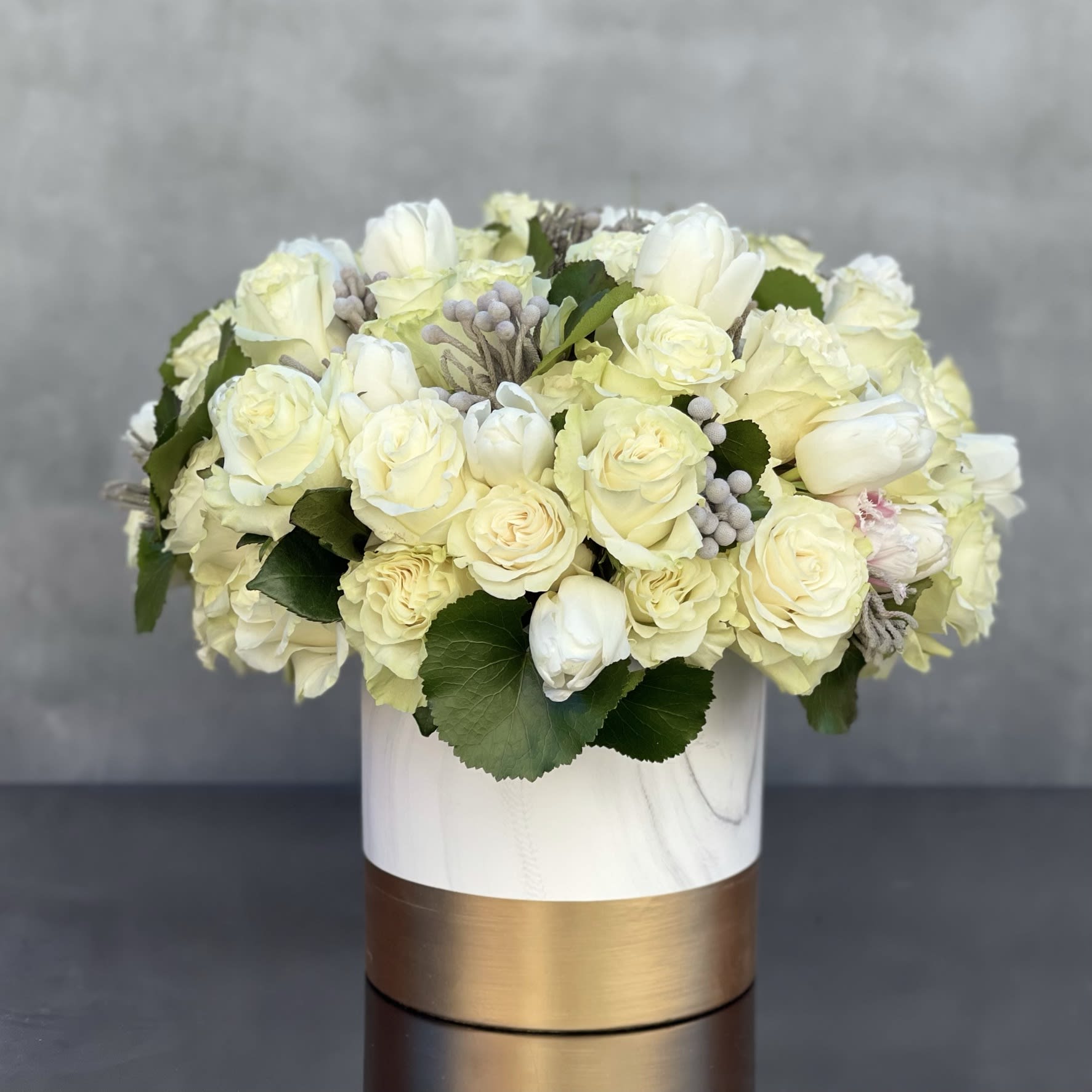 Golden whites - Sherman Oaks Florist - My Beverly Hills Florist presents, about 4 dozen of Creamy/White Roses and Bunches of Tulips with imported seasonal flowers. Arranged within an approx.: 13" round in a modern 8X8 Ceramic Vase.