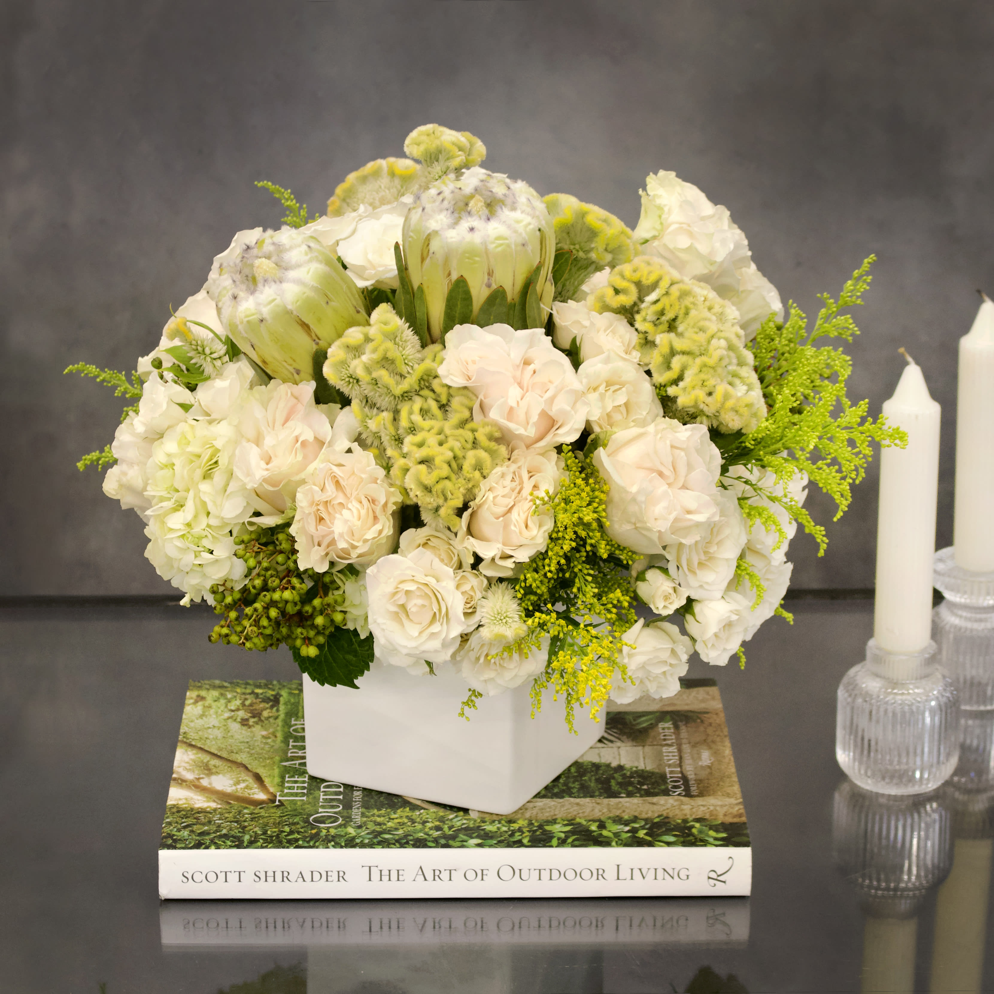 Designers Choice - Waiting To Exhale - Perfectly pure. Perfectly elegant. Astonishingly gorgeous. This mixed arrangement of   garden roses, spray roses, and other floral make this arrangement visually stunning while maintaining a simplicity that gives the viewer a peaceful calming feeling. Share the serenity with your loved one with this wonderful arrangement. 