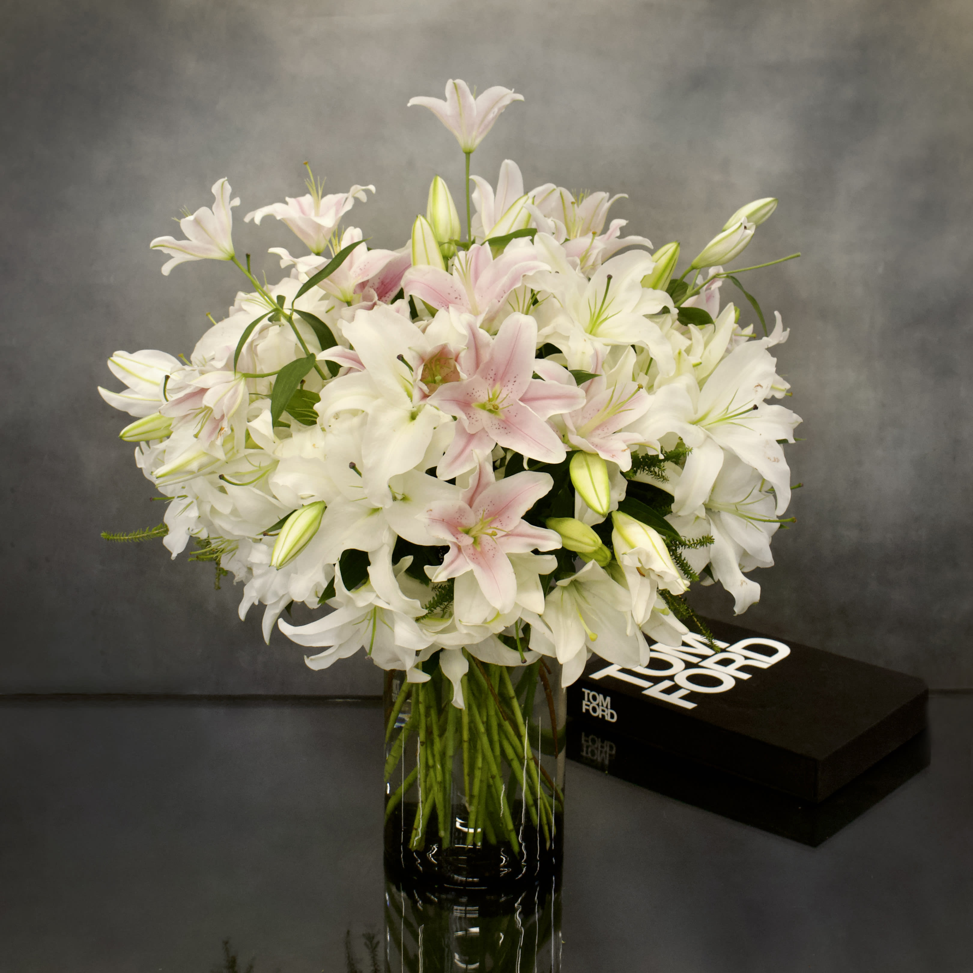 Duet Casablanca in a vase - Same-day delivery in Beverly Hills and local Los Angeles cities presents an opulent floral display featuring imported white and light pink Casablanca lilies from the Netherlands. Standing almost 32 inches tall, these lilies exude grandeur and sophistication, arriving in pristine, tight buds to ensure long-lasting freshness and a sweet fragrance that will enchant any space.  The design elegantly combines pink and white Casablanca lilies in a vase, showcasing a perfect balance of colors and luxurious blooms. A cherished favorite at My Beverly Hills Florist, this arrangement is sure to captivate with its exquisite beauty and timeless appeal. Treat yourself or a loved one to the alluring presence of these magnificent lilies, designed to bring joy and elegance to any occasion.