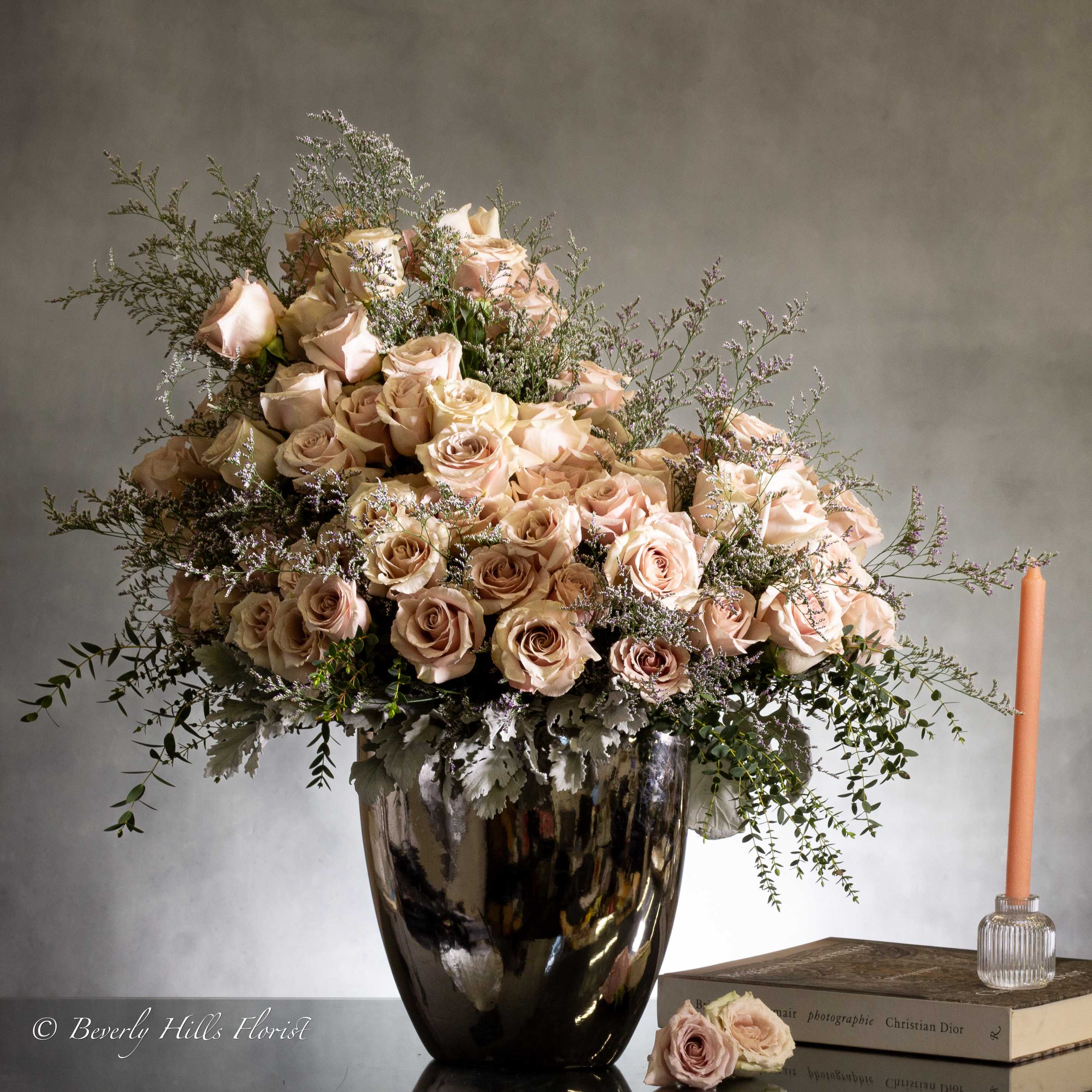 Sophia - Sherman Oaks Florist - Experience sophistication with a breathtaking arrangement of fifty opulent sand-colored roses in a chic silver vase. Combining contemporary flair with charming elements, this display exudes refined elegance and romantic allure. 50 blooms of sand-colored roses are beautifully arranged in a  22x18 "silver container. Available with 100 or 150 roses in a 32x26" container.