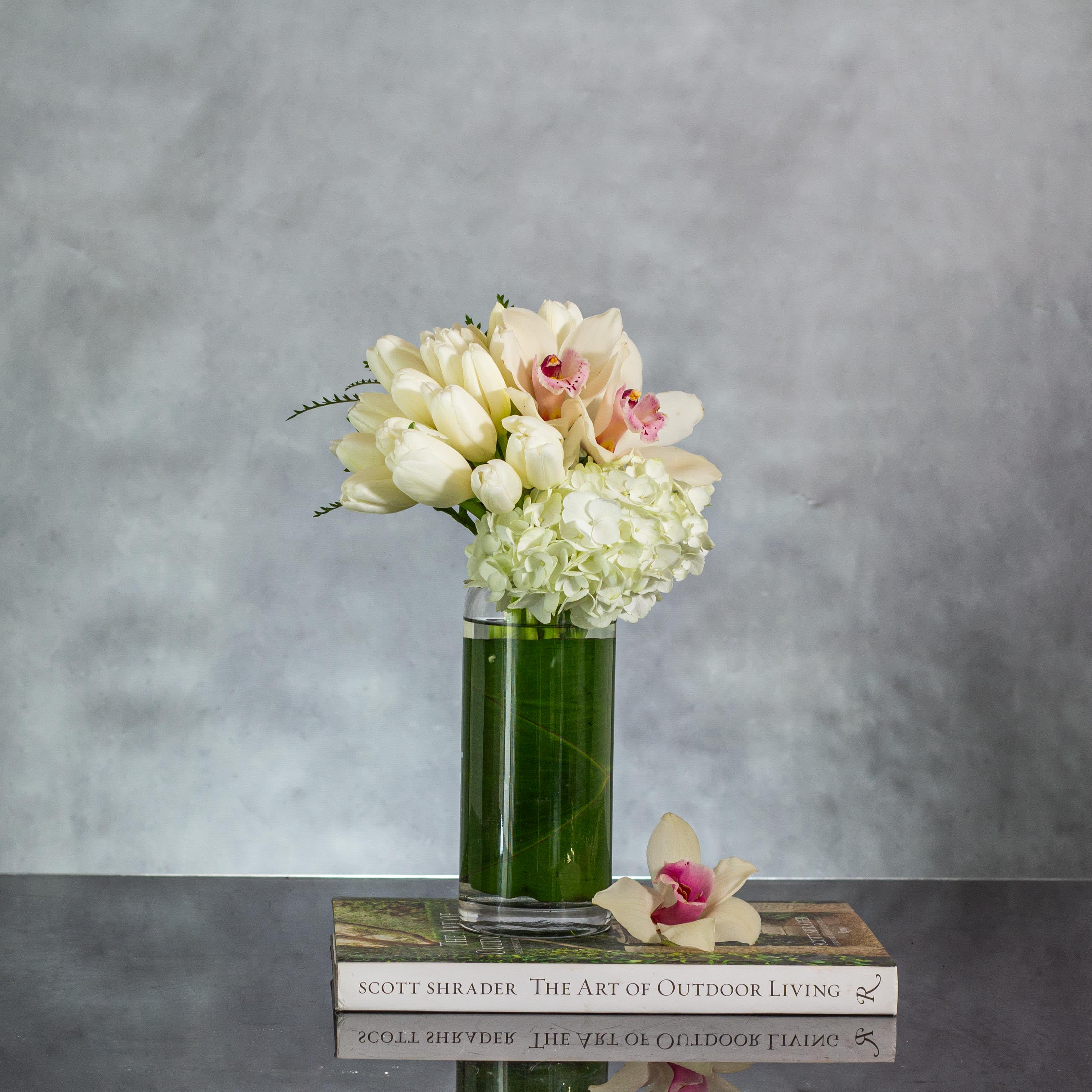 Free-Form Tulips - My Beverly Hills Florist presents a dramatic display of Dutch Tulips and a single Orchid in a Cone glass vase. This stunning composition gives a unique and stylish look to any space.  Approx: 11" Tall
