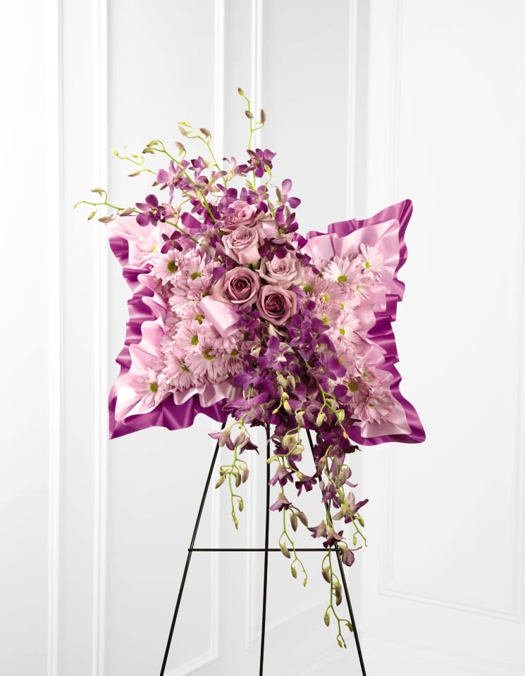 Pink and purple floral standing spray on an easel