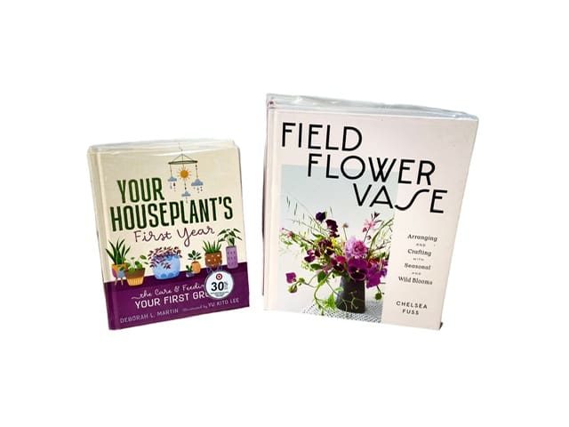 Two gardening books with plant and flower covers on a white background