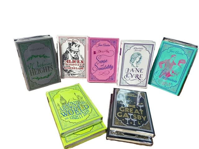 Stacked decorative book-shaped boxes in assorted colors