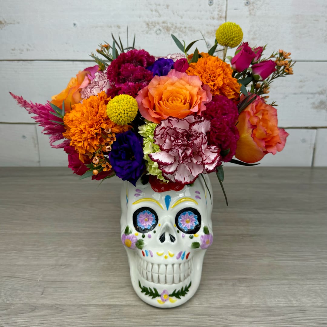 Colorful bouquet in a painted skull vase