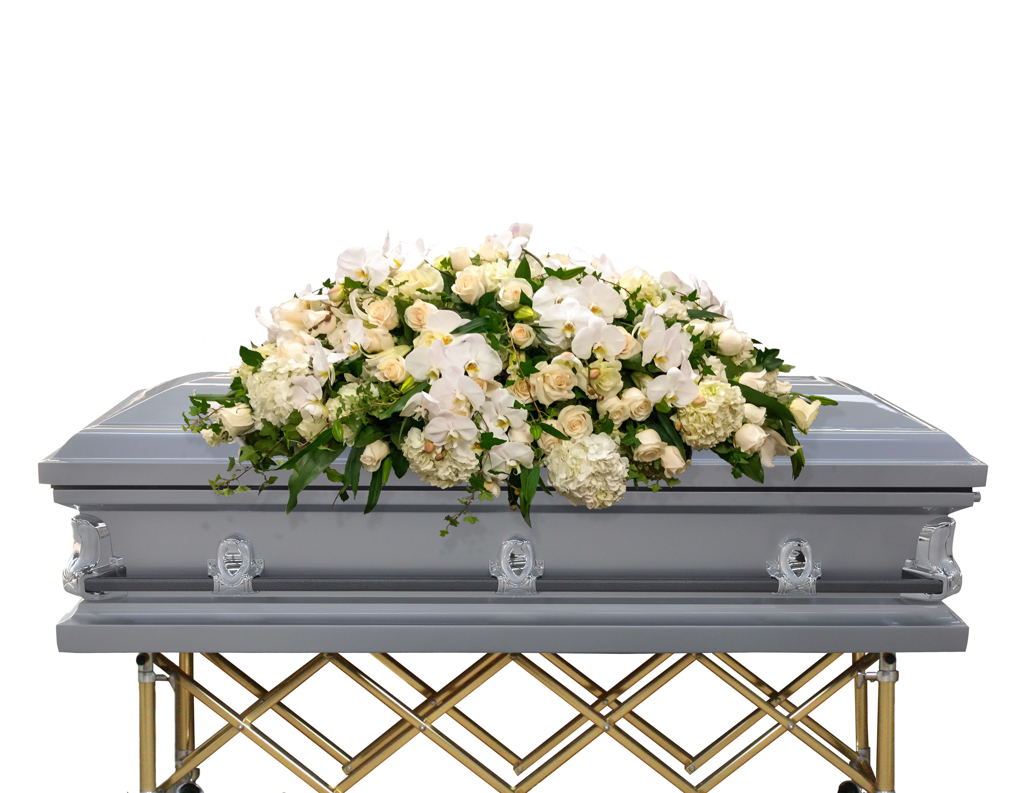 White floral casket spray on a gray casket