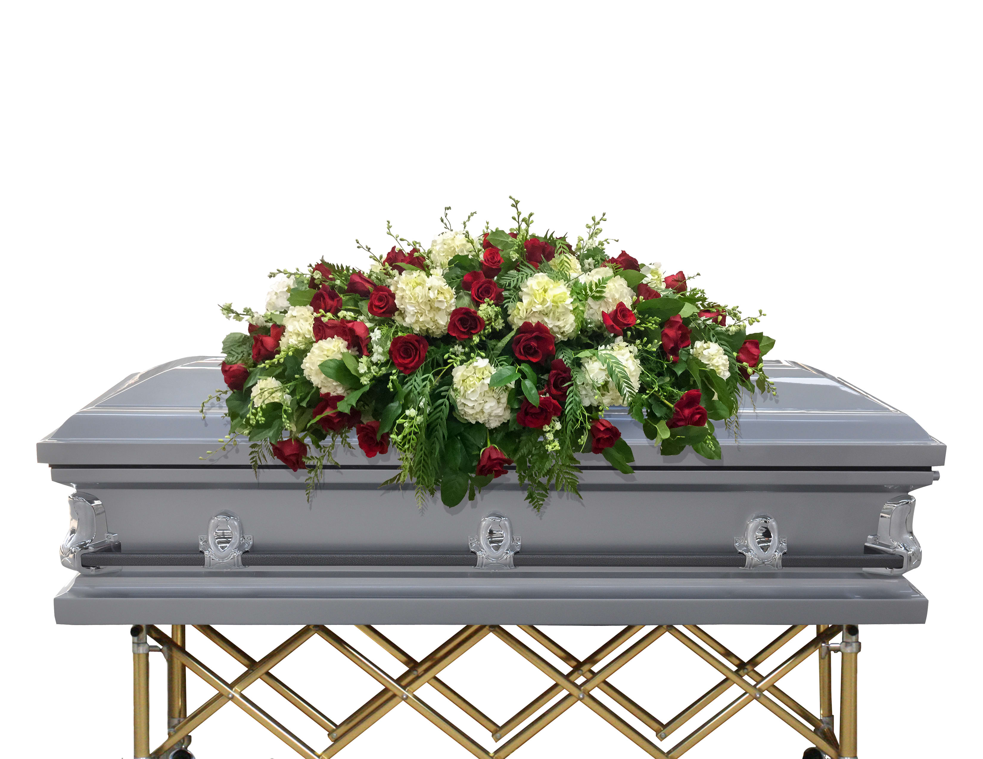 Red and white floral spray on a silver casket