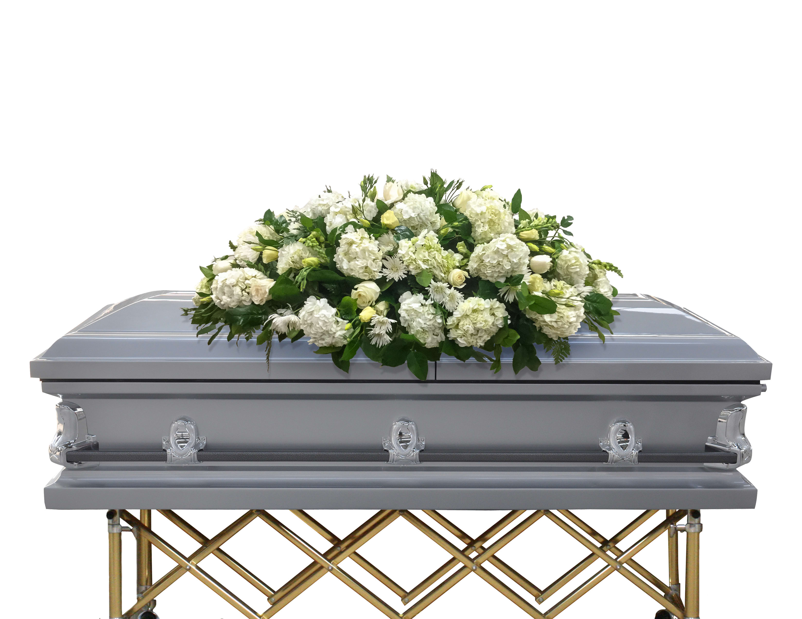 White floral casket spray on a silver casket