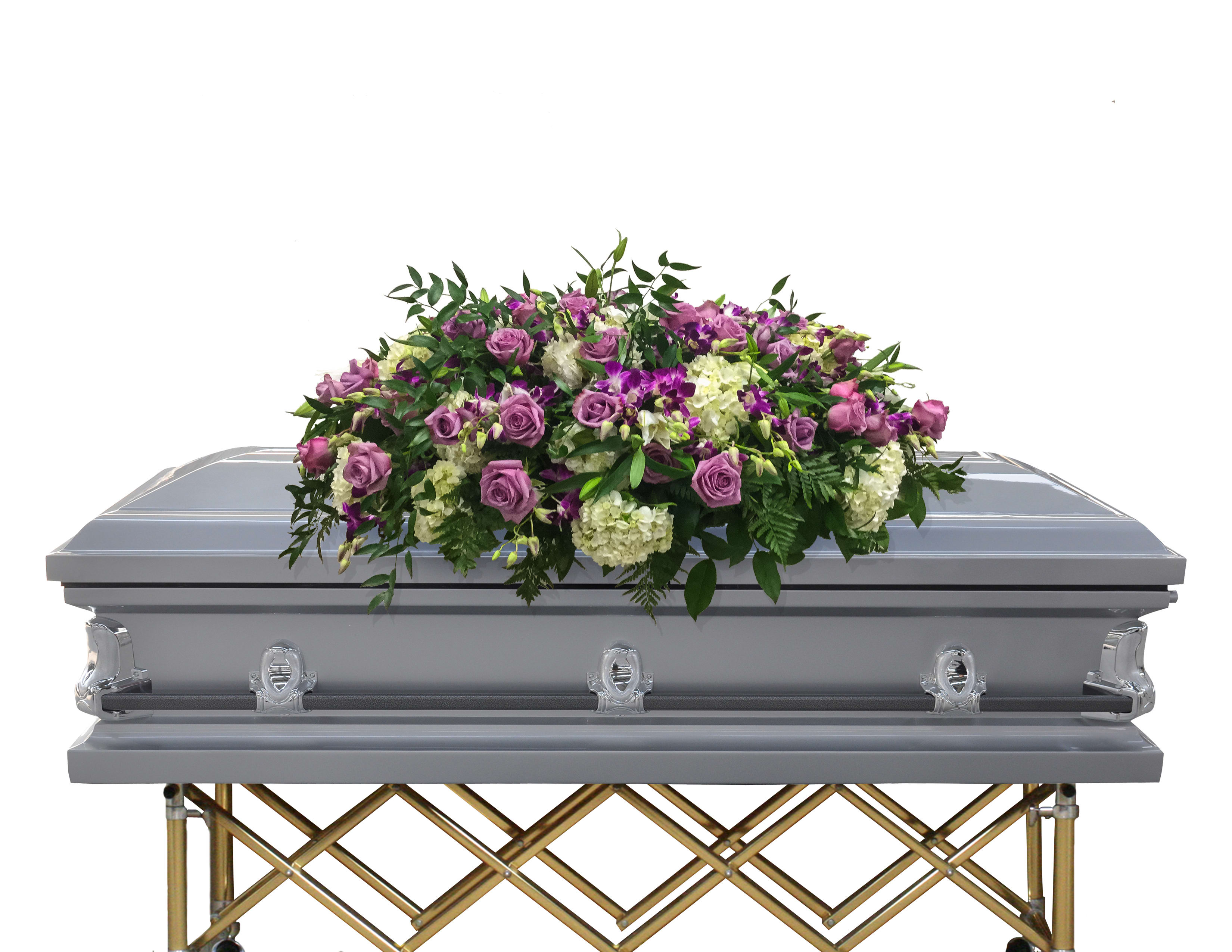 Purple rose and white flower casket spray on a gray casket