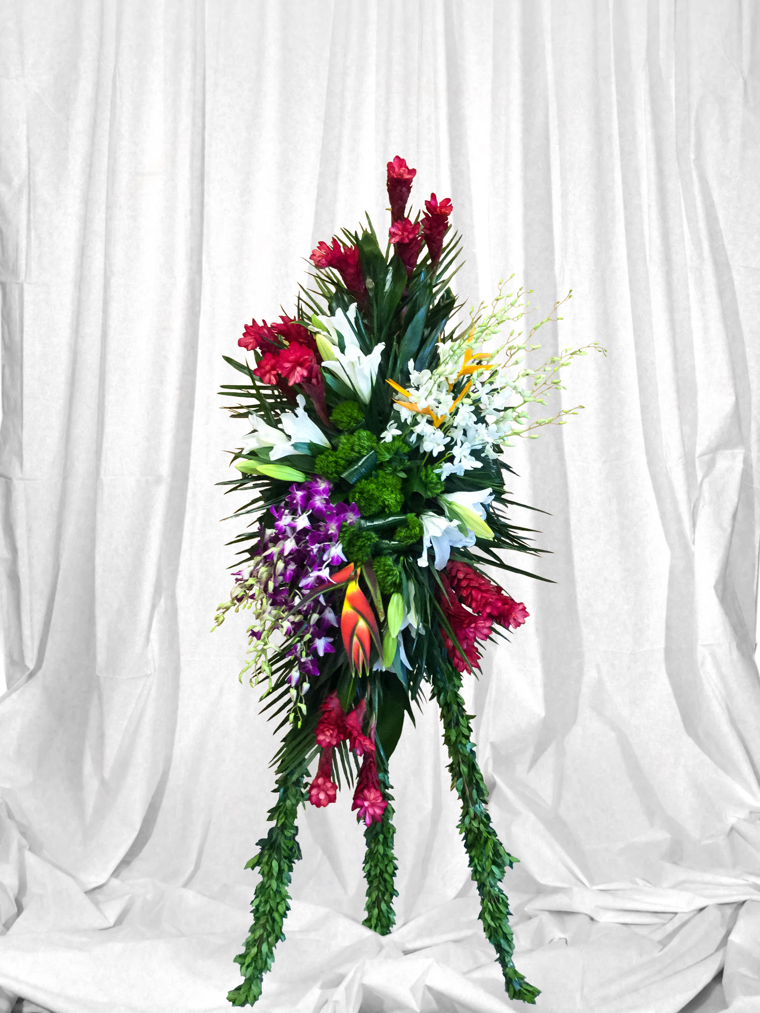Tall tropical floral standing spray with red, white, purple, and orange blooms