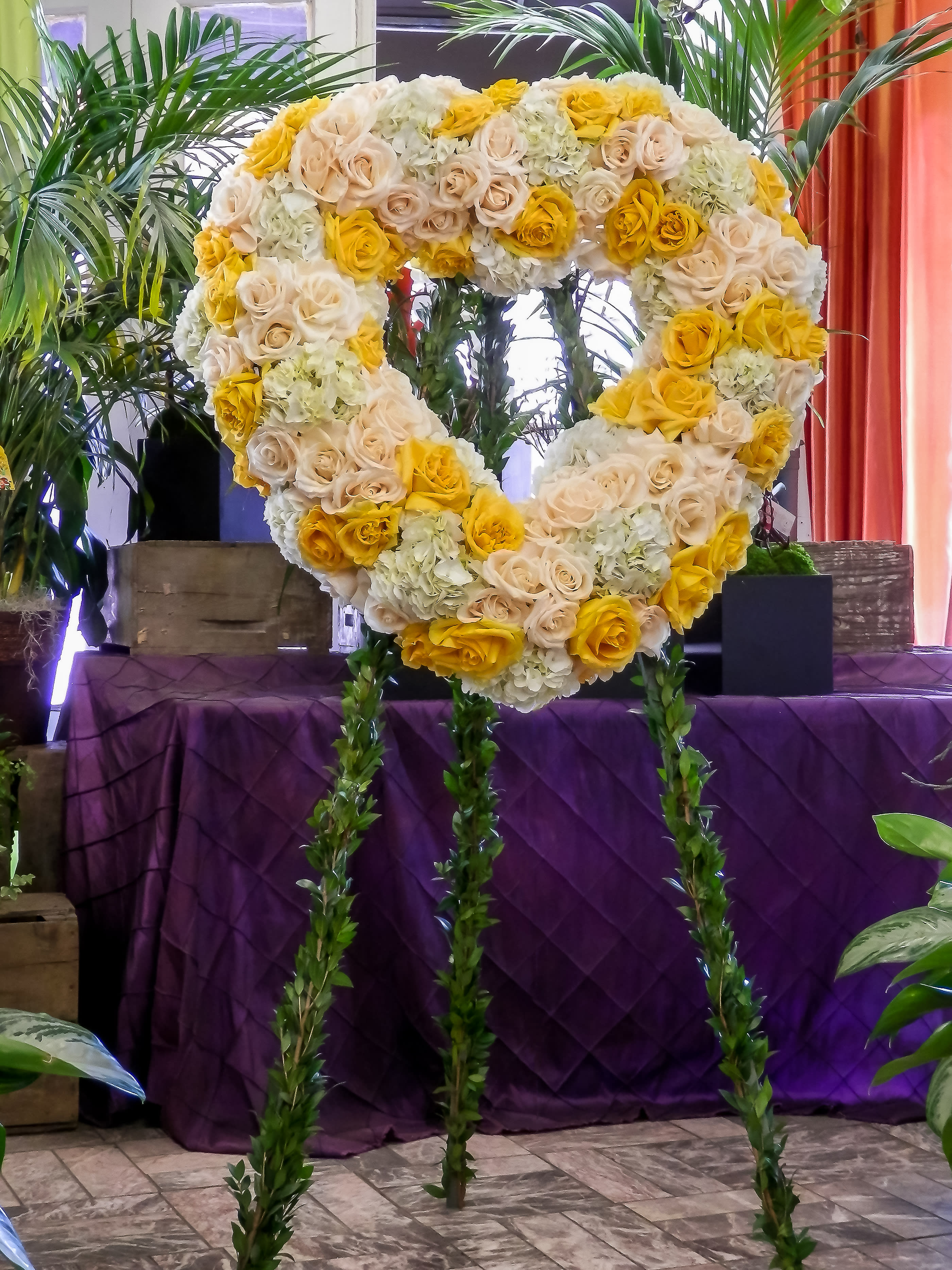 Heart-shaped floral standing spray with yellow and cream roses