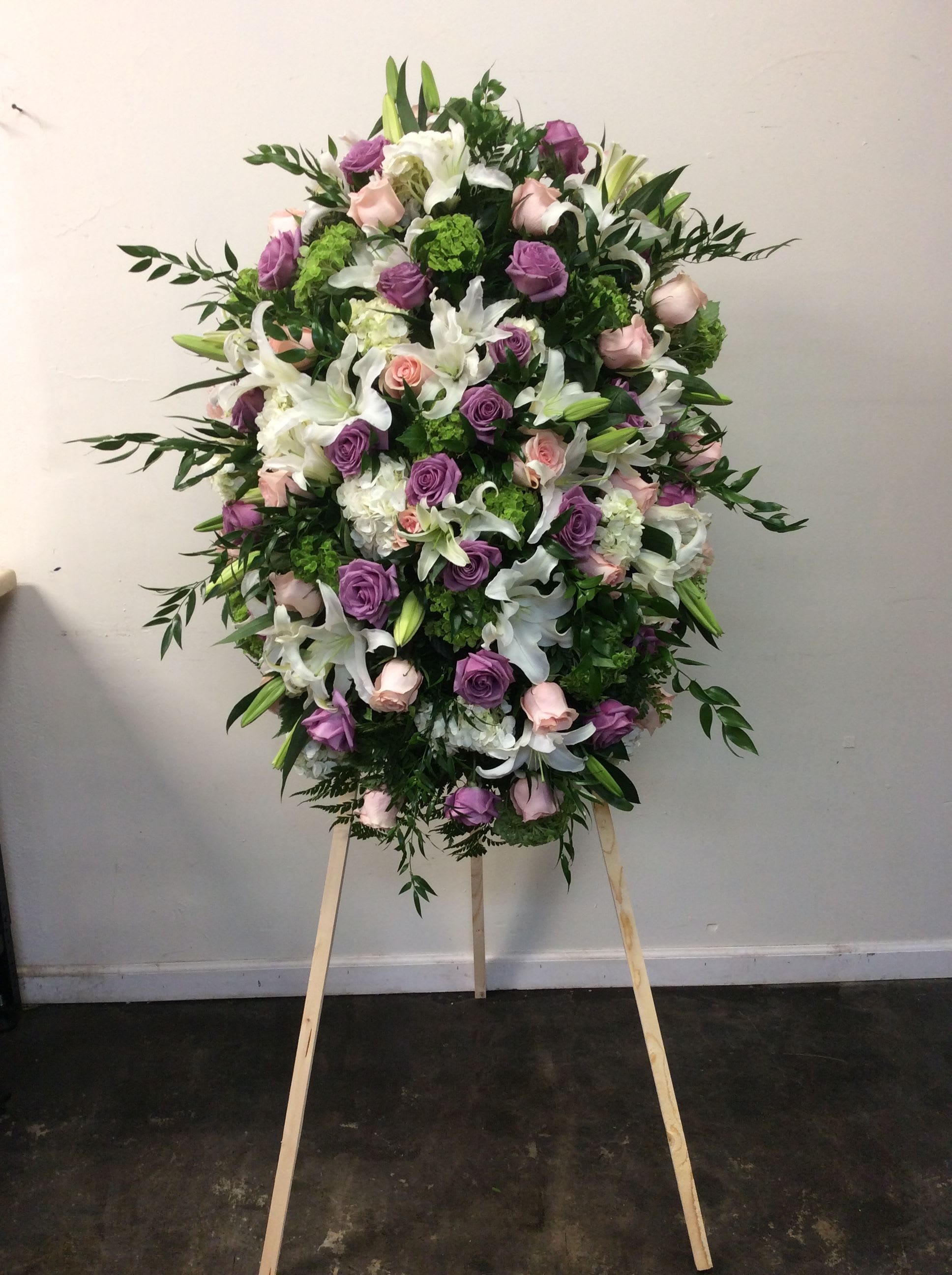 Large standing floral spray with pink, purple, and white flowers