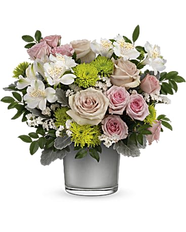 Pink and white roses with white alstroemeria in a glass vase