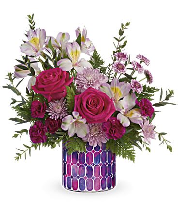 Pink roses and pale lilies in a patterned vase