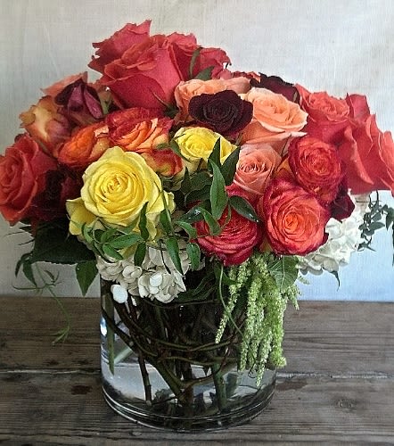 Mixed roses in a clear glass vase