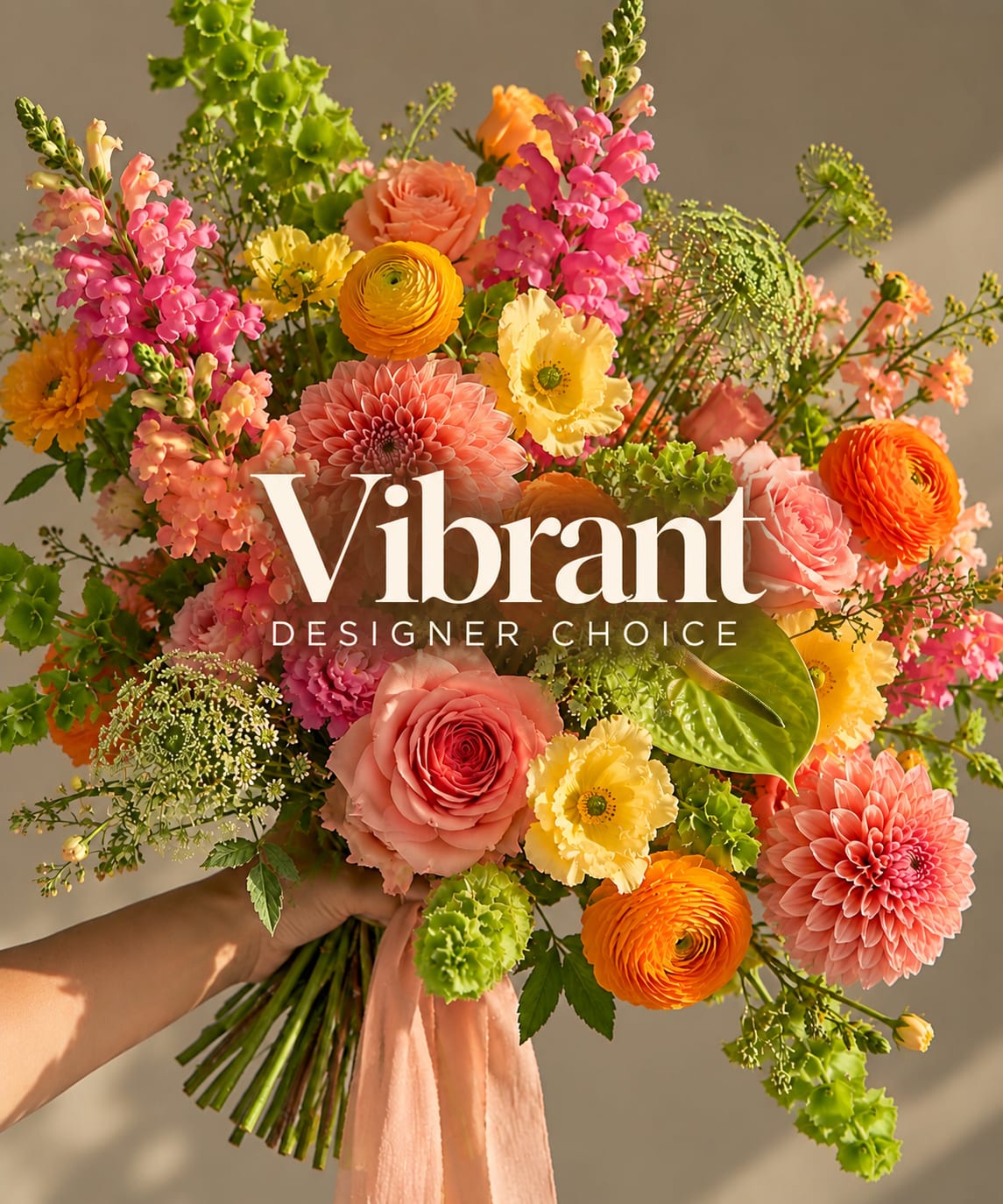 Handheld bouquet of pink, peach, yellow, and orange flowers with a ribbon tie