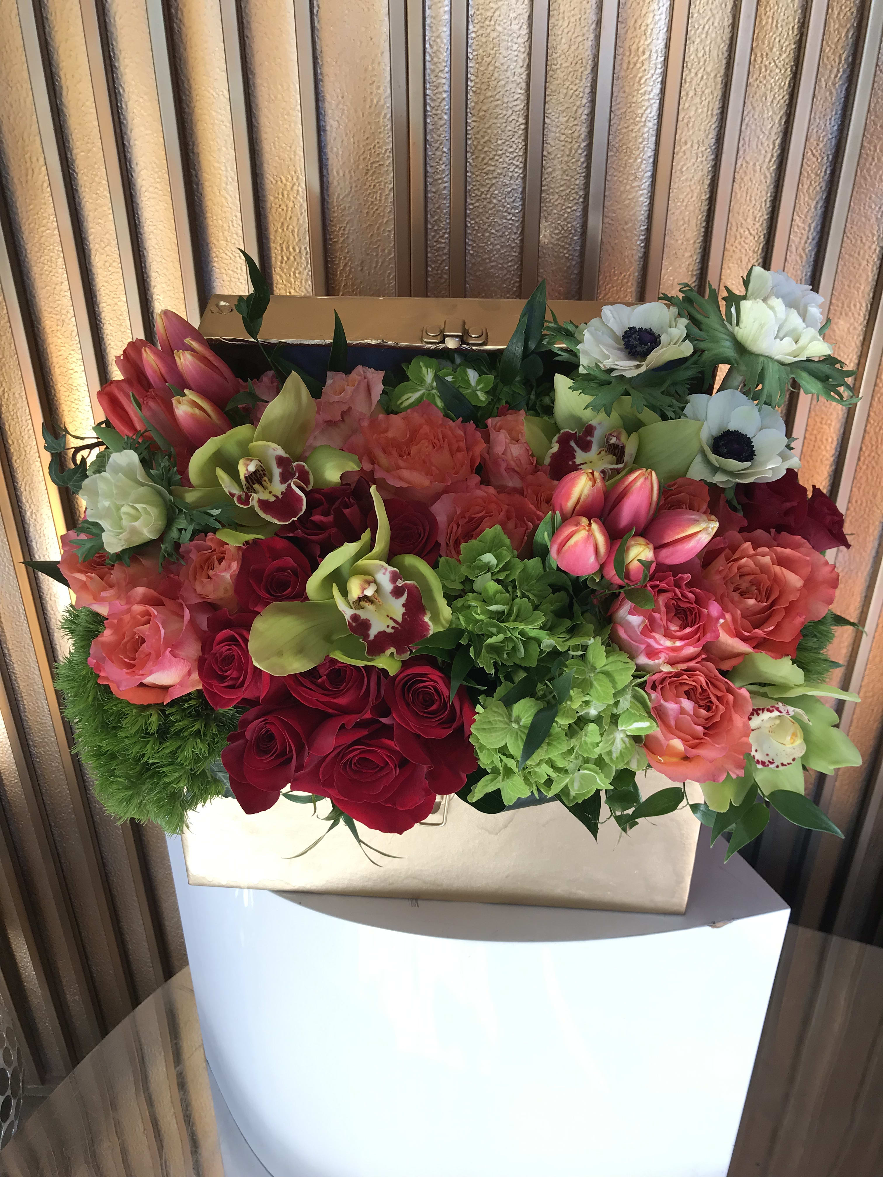 Mixed bouquet in a gold box with red, pink, and white blooms