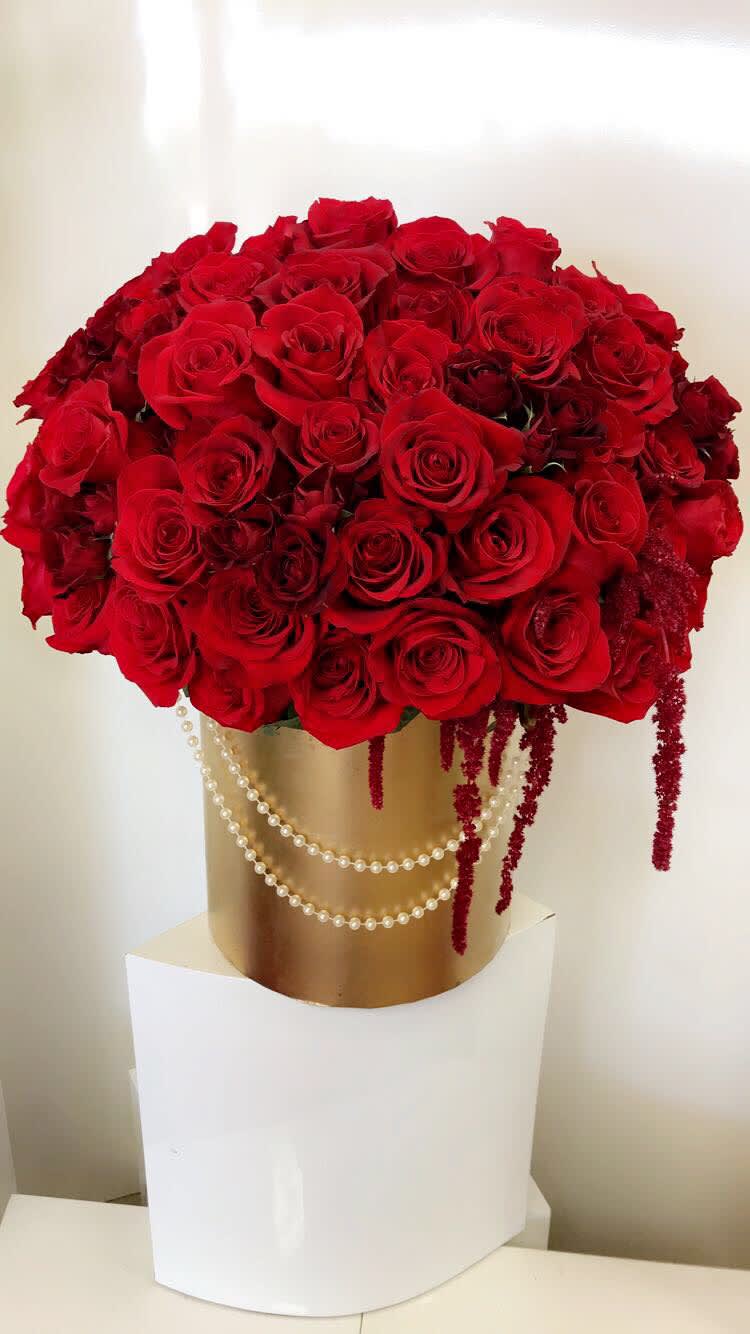 Large bouquet of red roses in a gold box with pearl strands