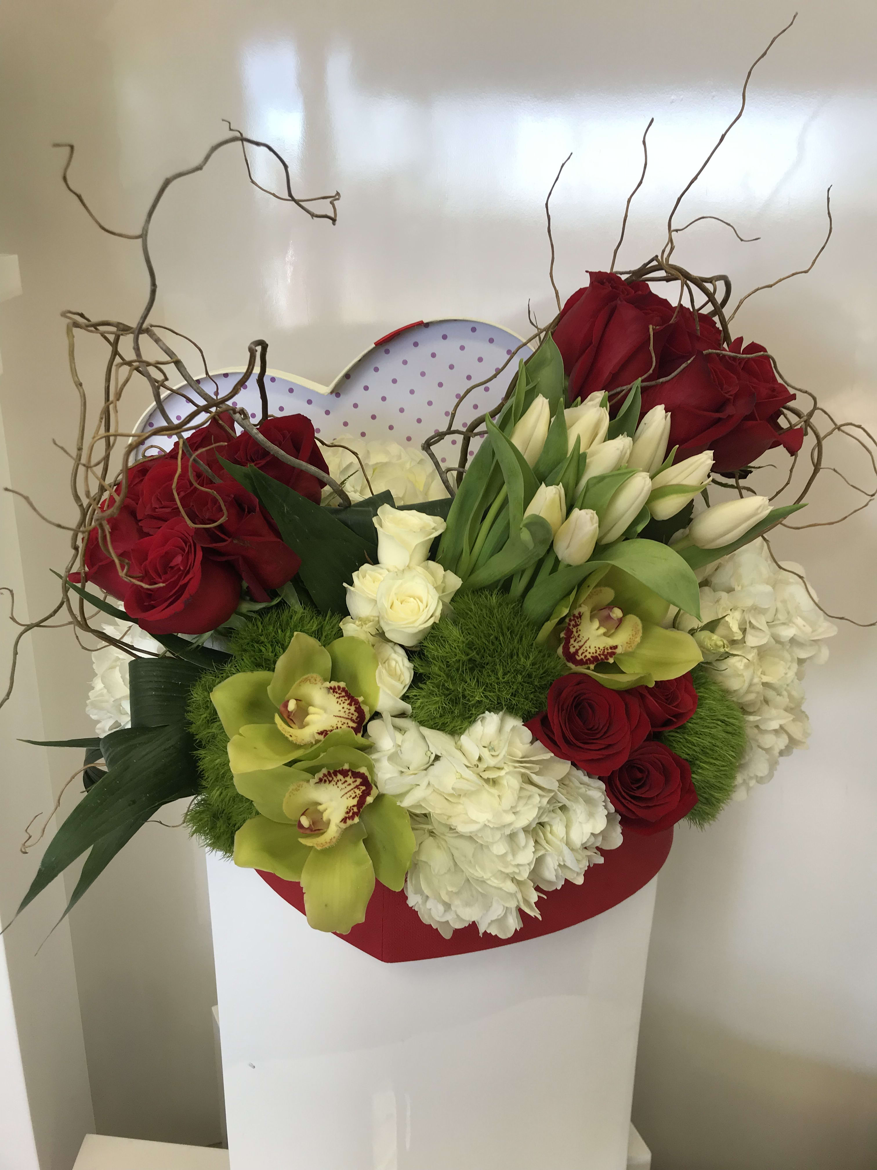 Open Heart  - Designer arrangement of gorgeous roses, tulips and orchids in a unique heart shaped box. 