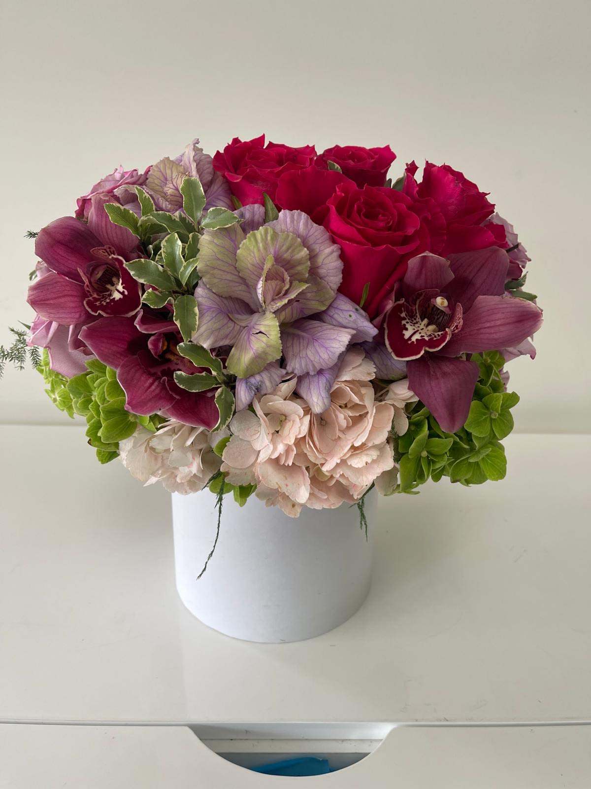 Lucy  - Designer arrangement of fresh hydrangeas, roses, orchids and greens in a beautiful keepsake vase. 