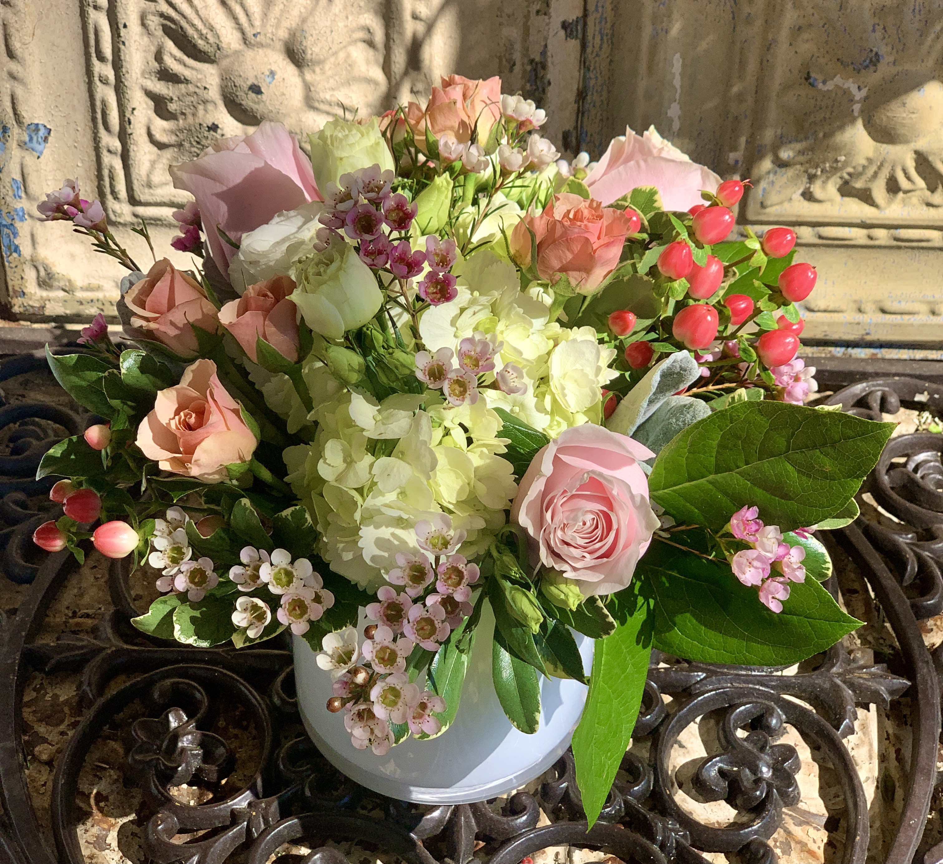 Pink and white rose bouquet in a white vase