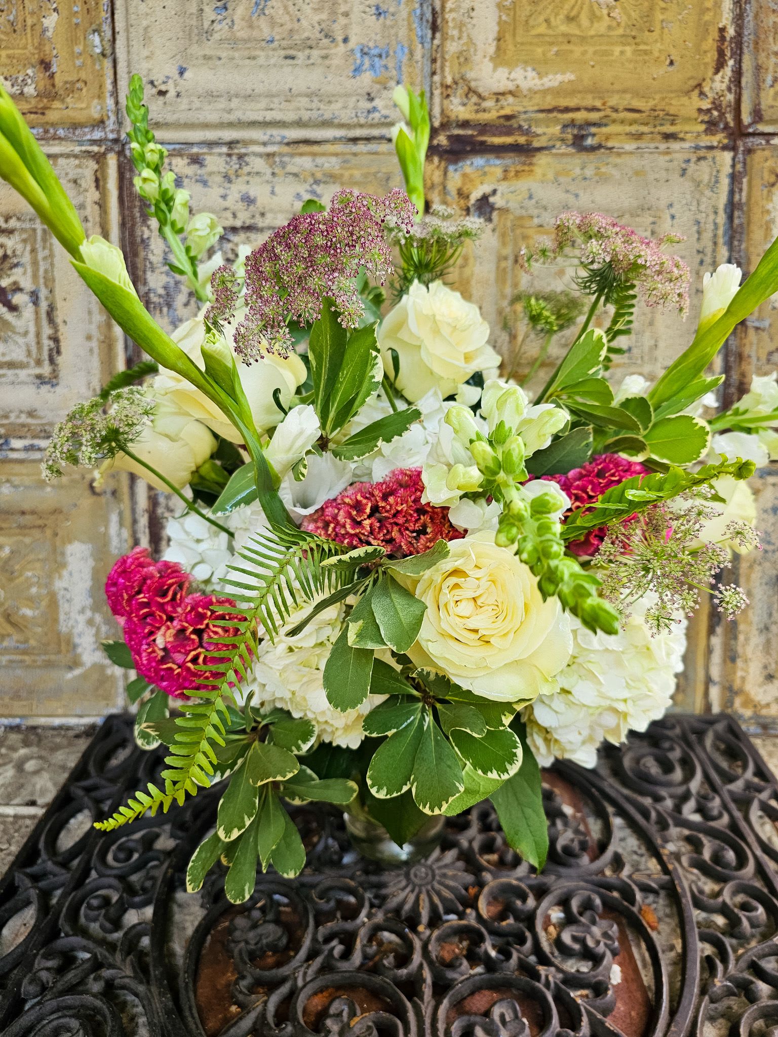 Bouquet of cream roses and white blooms with pink accents