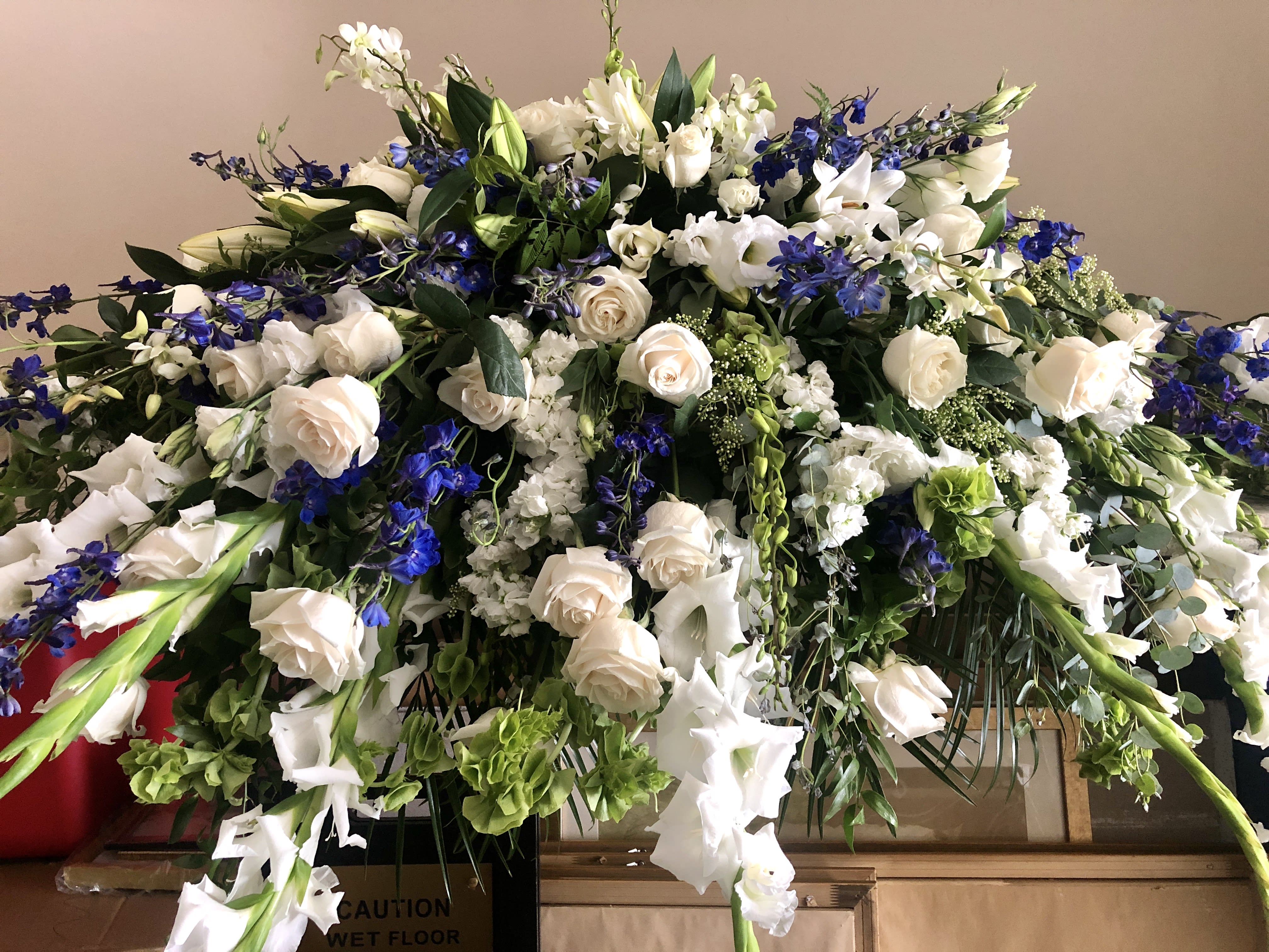 Large white and blue floral spray with roses and lilies