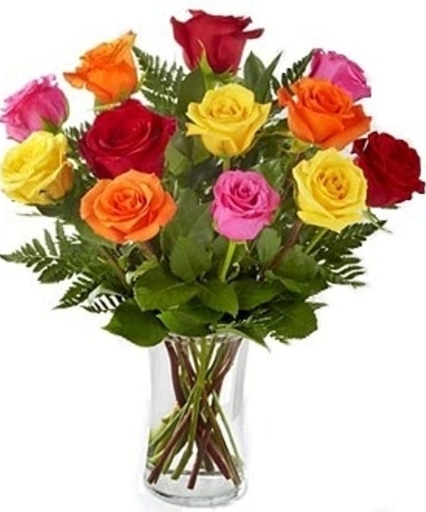 Bouquet of multicolored roses in a clear glass vase