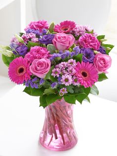 Pink and purple mixed bouquet in a pink glass vase