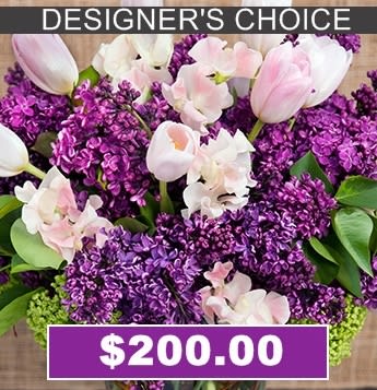 Purple and pink floral arrangement with tulips and orchids