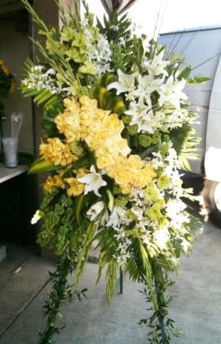 Tall standing floral spray with white lilies and yellow roses