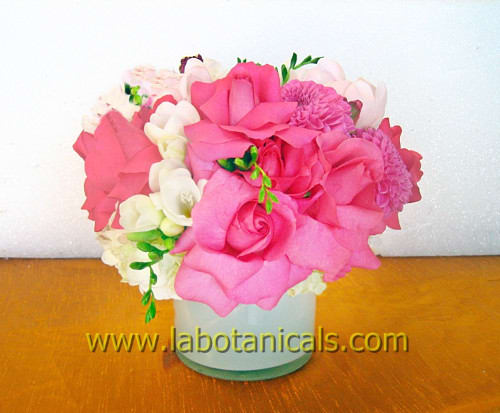 Pink and white flower arrangement in a white vase