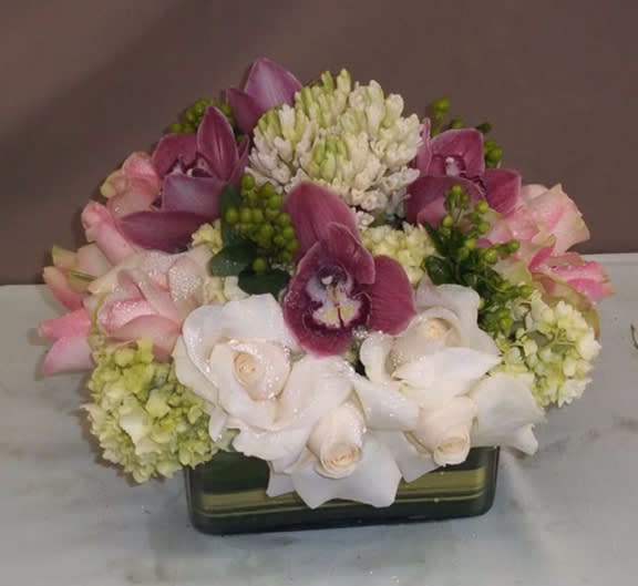 Pink and white floral arrangement in a rectangular vase