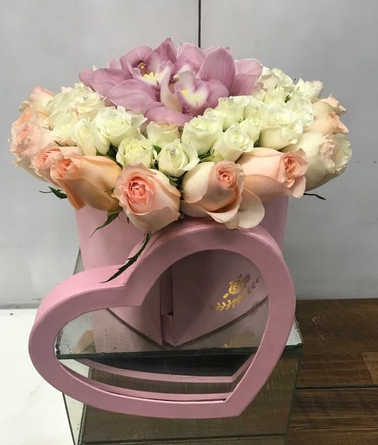 Pink and white rose bouquet in a pink heart-shaped box