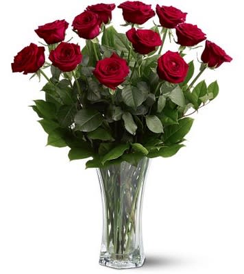 Red roses arranged in a clear glass vase
