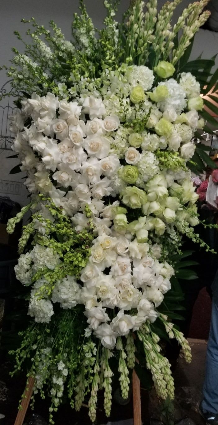 Large white and pale green floral standing spray with roses and orchids