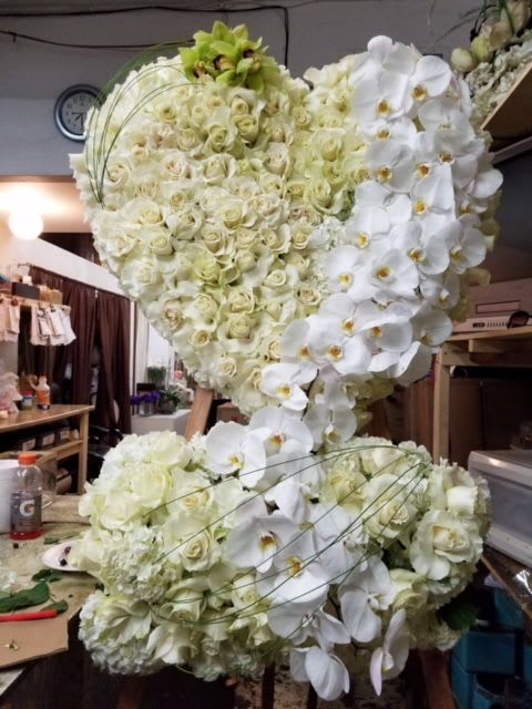Large white floral heart arrangement with roses and orchids