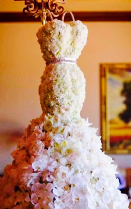 Tall tiered floral arrangement with white and pink flowers