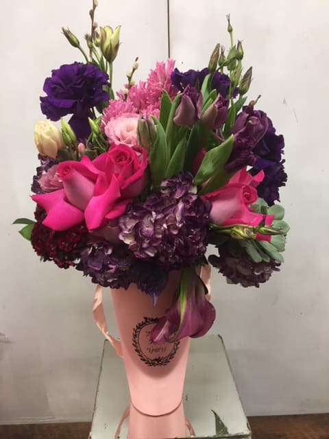Bouquet of pink and purple flowers in a pink wrap
