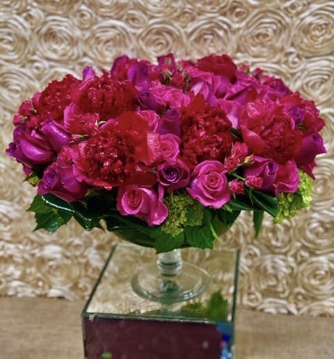 Pink and red rose arrangement in a clear glass vase