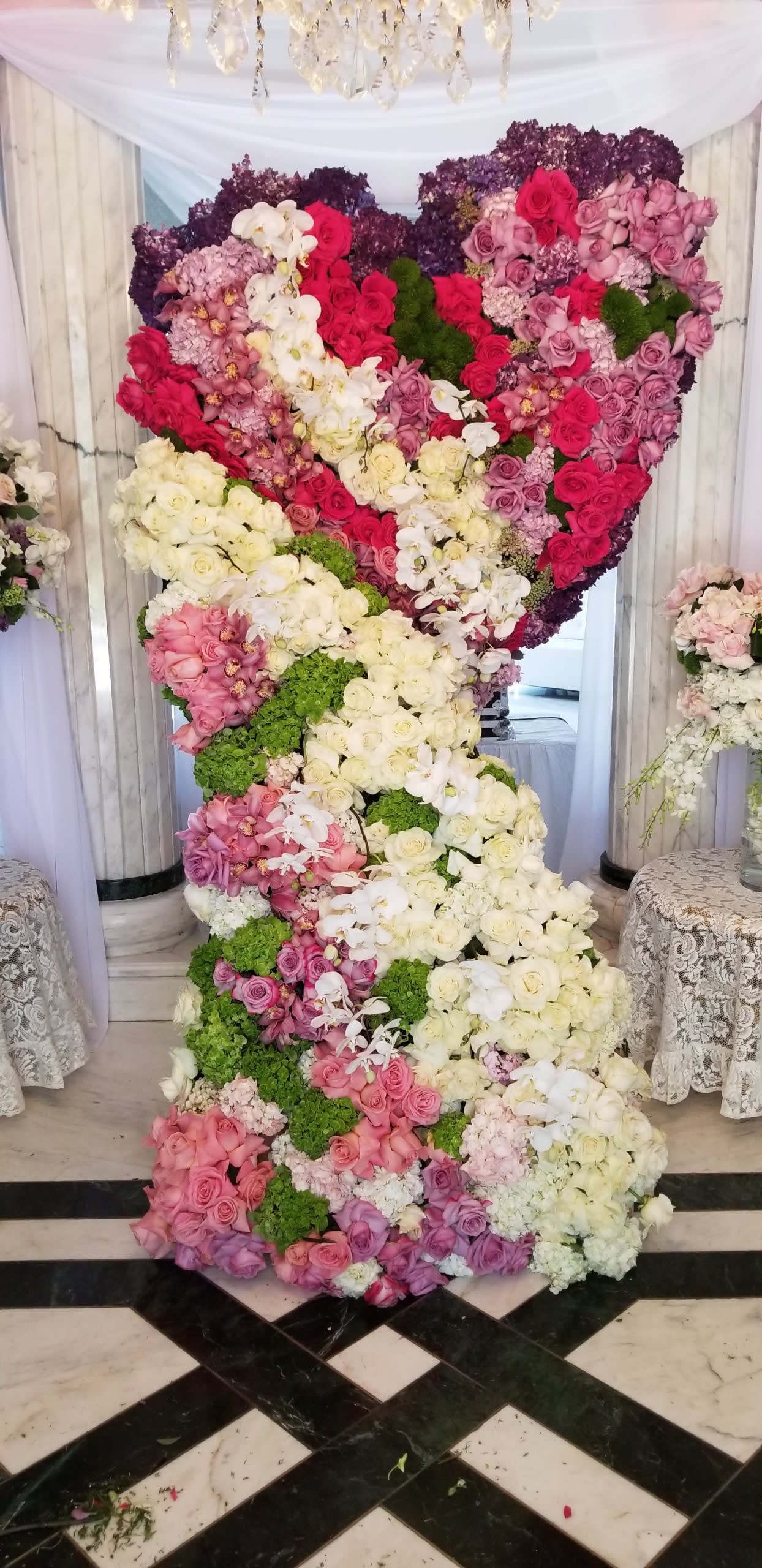 Large floral display shaped like a number 2 with pink, white, and purple flowers