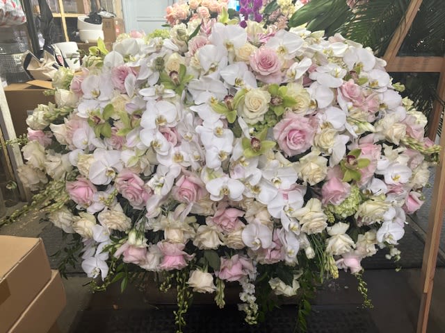 Large arrangement of white orchids and pale pink roses