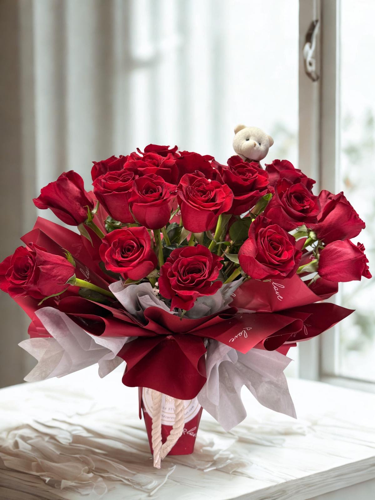 Eternal Scarlet Embrace - An elegant bouquet of premium red roses, beautifully wrapped, perfect for expressing timeless love