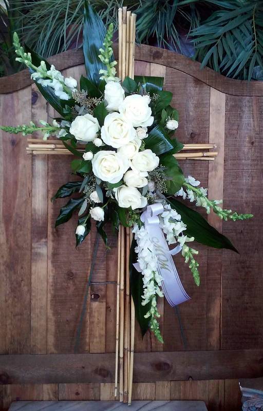 Bamboo Cross  - White roses and snapdragons, accented with tropical foliage and a river cane cross.