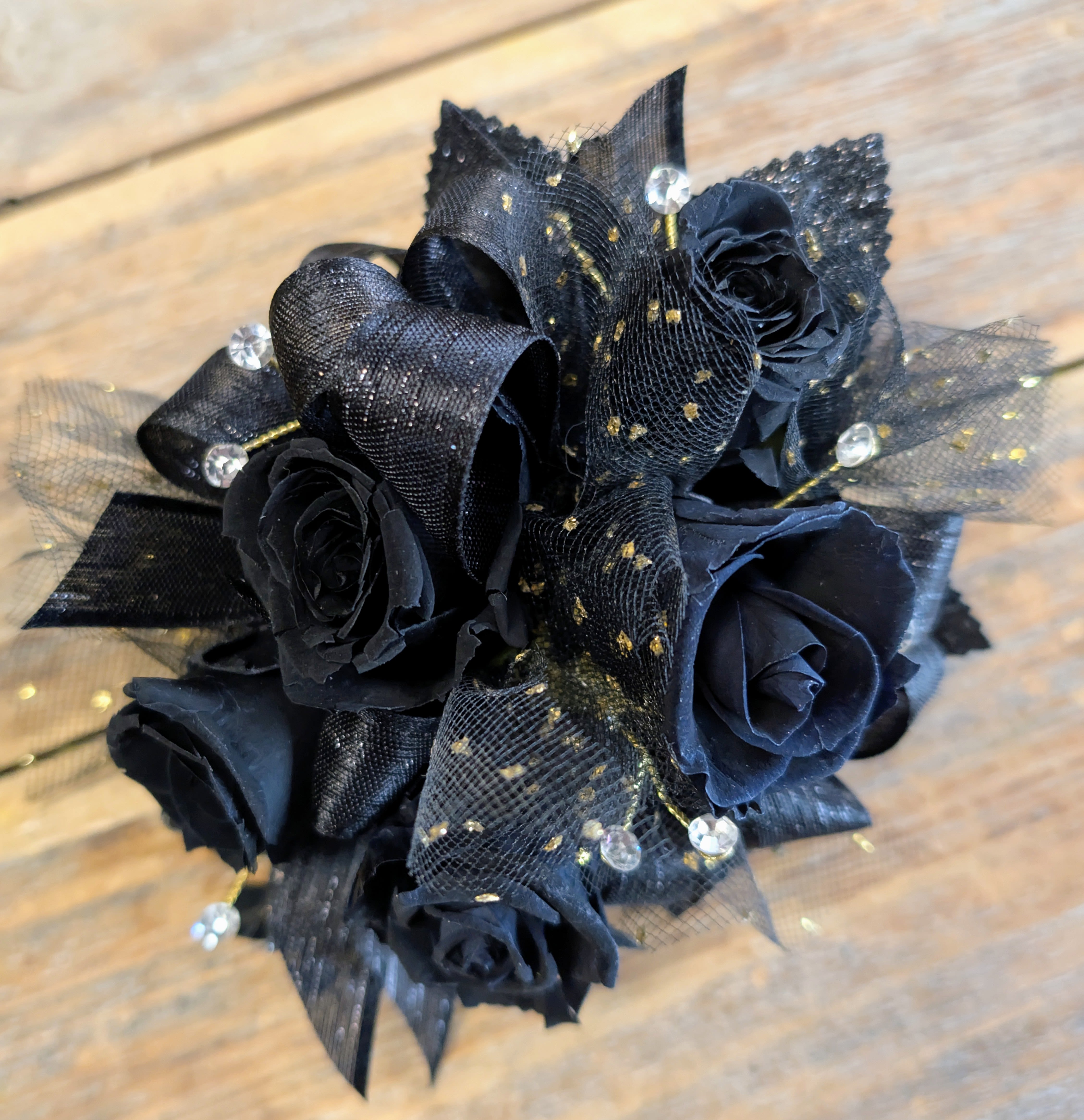 Black rose bouquet with sheer black ribbon and gold accents