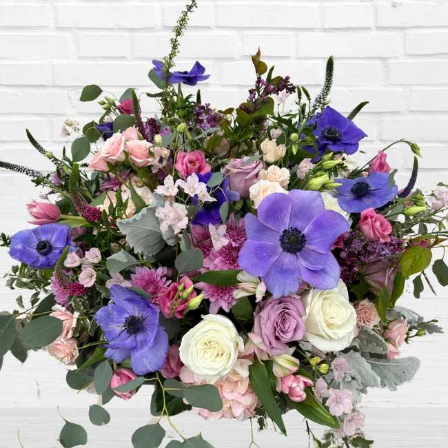 Mixed bouquet with purple anemones and pink and white roses
