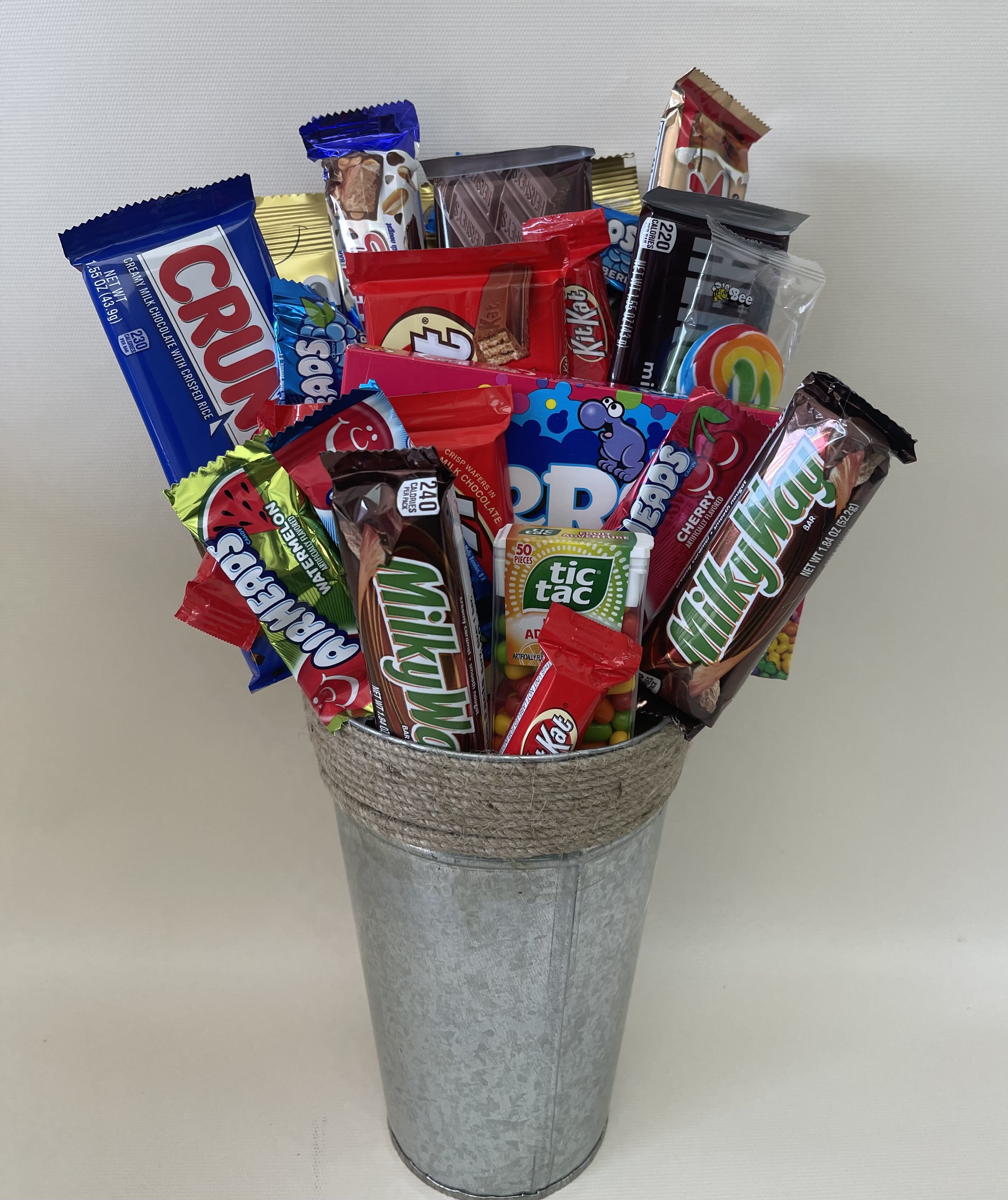 Assorted candy bars arranged in a galvanized metal bucket