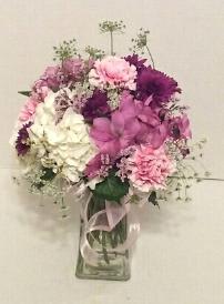 Pink and purple mixed bouquet in a clear glass vase