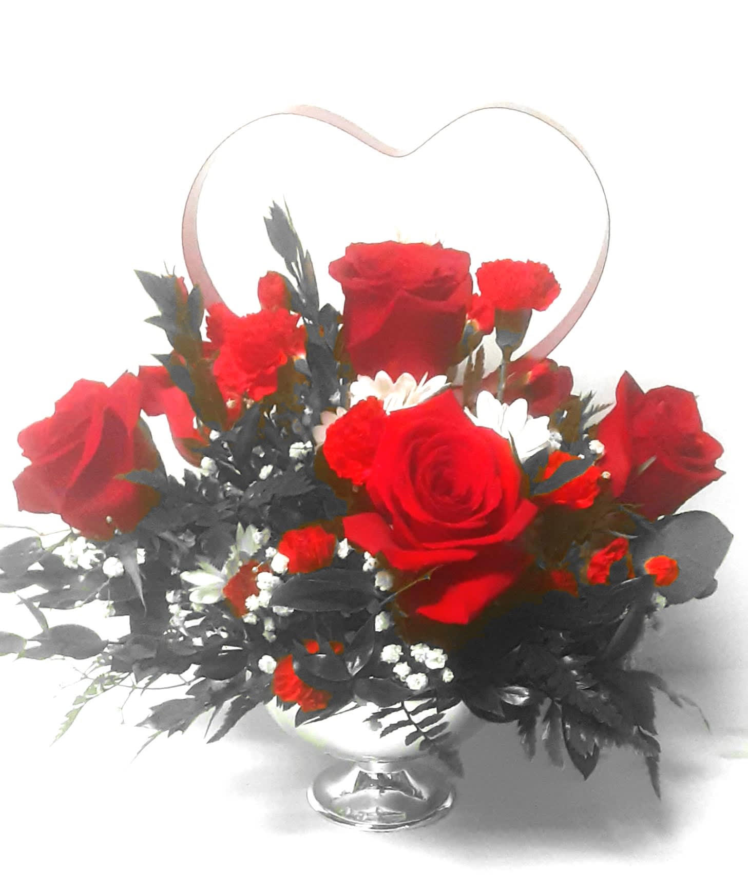 Red roses and carnations in a silver vase with a heart-shaped handle