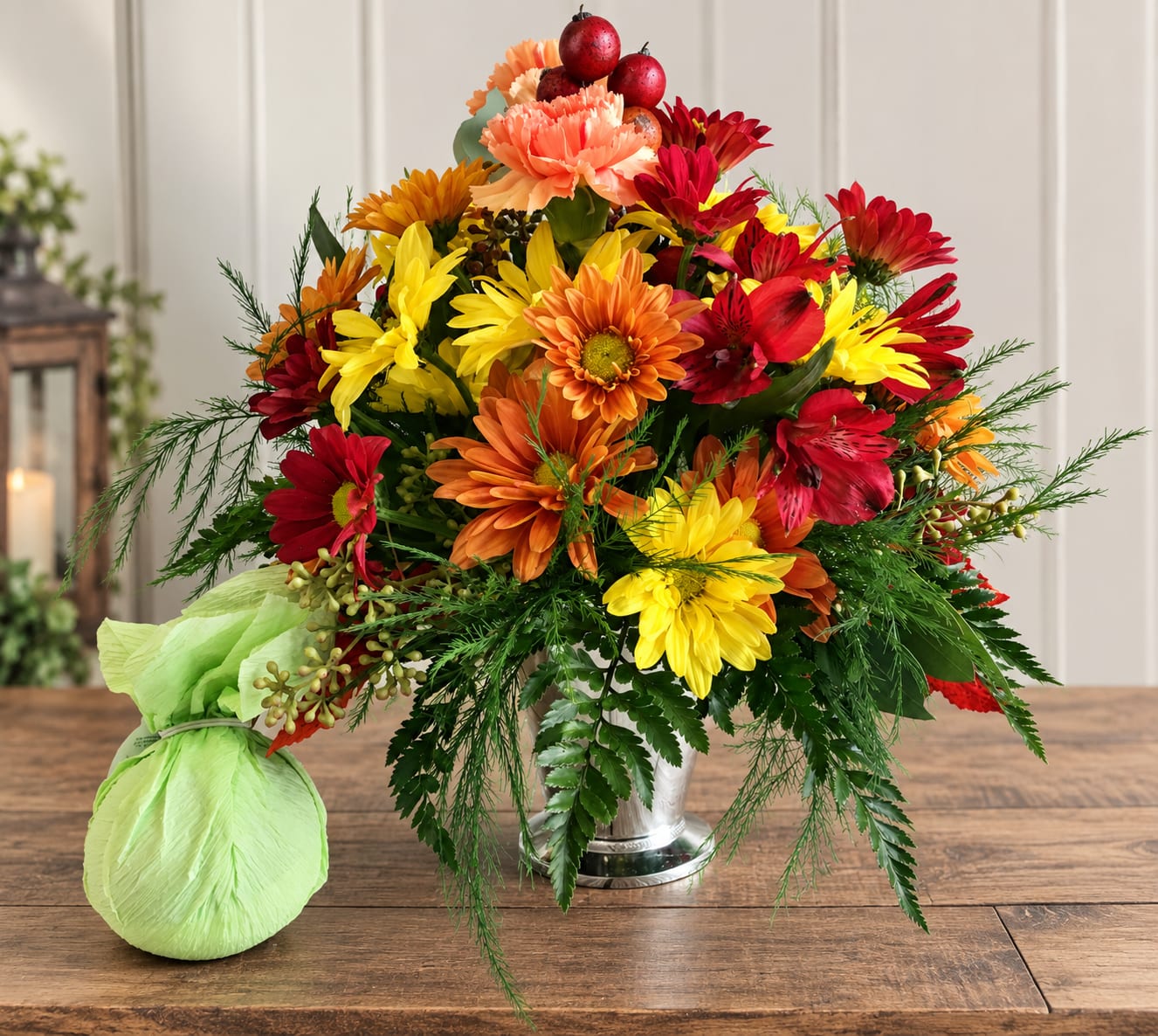 Bright mixed bouquet in a silver vase with a green wrapped accent